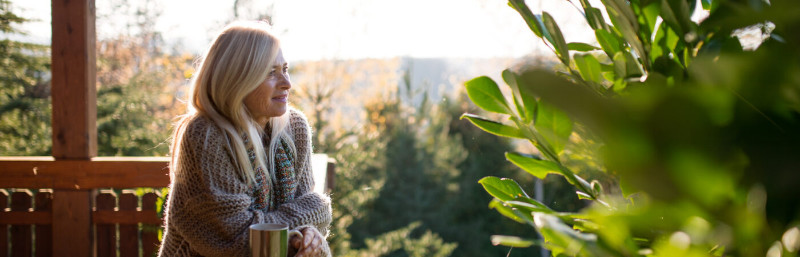 A woman having coffee looking afar